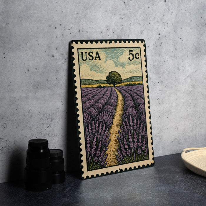 A framed postage stamp depicting a field of lavender flowers, with a road leading through the scene.