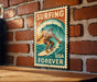 A vintage-style metal sign with a surfer riding a wave, mounted on a brick wall.