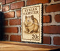 A wooden table with a metal stamp featuring a hamster on it, mounted on a brick wall.