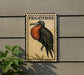 a sign with a bird illustration, mounted on a wall next to a plant.