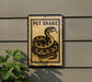 a sign with a picture of a pet snake on it, mounted on a wall.