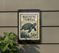 A sign that reads "Aquatic Turtle" and "50¢" is mounted on a wall, with a plant visible to the left.