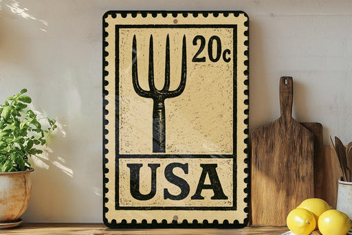 A vintage-style sign with a fork and knife design, mounted on a wall next to a wooden cutting board and some kitchen utensils.