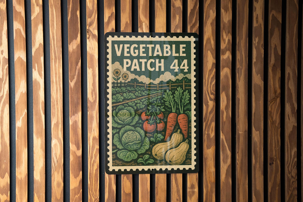 A vintage-style metal sign with a vegetable patch design, mounted on a wooden wall.