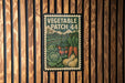 A vintage-style metal sign with a vegetable patch design, mounted on a wooden wall.