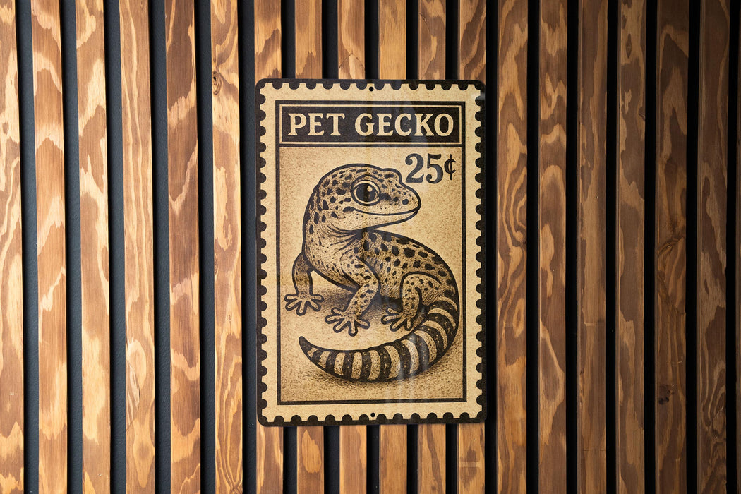 A metal sign with a gecko on it, mounted on a wooden wall.