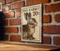 A vintage-style metal sign featuring a rabbit on a brick wall.