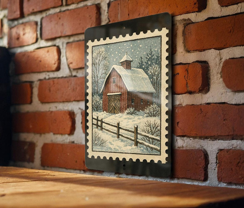 A framed painting of a red barn with a snowy landscape is hanging on a brick wall.