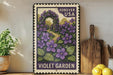 A vintage-style postage stamp featuring a purple garden scene with purple flowers and a wooden archway, displayed on a shelf next to a wooden cutting board and a potted plant.