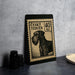 A black and white postage stamp featuring a dog, placed on a countertop next to some black camera lenses.