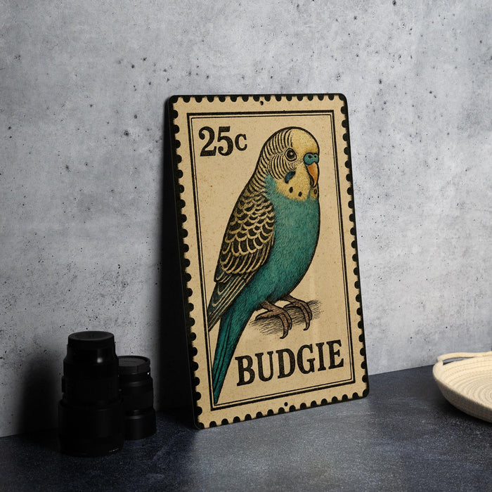 A metal stamp featuring a colorful illustration of a budgie bird, with the text "25c" printed on it.
