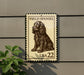 A metal sign with a picture of a Field Spaniel dog, mounted on a wall.