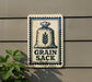 a sign with the text "Grain Sack" and an illustration of a bag of grain.