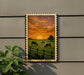 a serene rural scene with a group of cows grazing in a lush green field, framed by a wooden fence and a vibrant sunset sky.