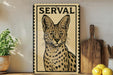A framed illustration of a serval cat is displayed on a shelf, accompanied by a wooden cutting board, a potted plant, and some lemons.