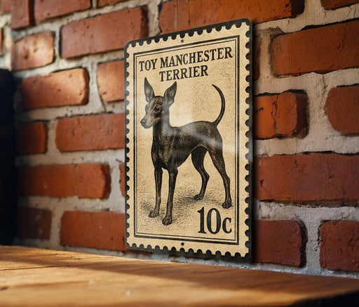 A vintage-style metal stamp depicting a toy Manchester Terrier, with the text "TOY MANCHESTER TERRIER" and the denomination "10c".