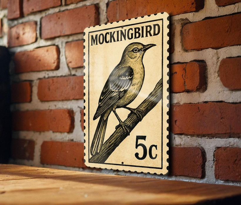 A vintage postage stamp featuring a bird, likely a Mockingbird, is displayed on a brick wall.