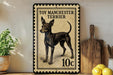A vintage-style metal stamp depicting a toy Manchester Terrier, with the text "TOY MANCHESTER TERRIER" and a value of 10 cents.