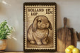 A wooden frame with a printed image of a rabbit, which appears to be a postage stamp, is displayed on a shelf next to a wooden cutting board and some lemons.