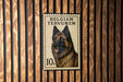 A postage stamp featuring a picture of a Belgian Terrier dog.