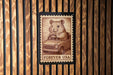 A postage stamp featuring a cartoon image of a hamster driving a car, with the text "FREVER USA" printed below it.