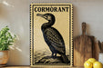 a decorative cormorant sign with a black and white illustration of a bird perched on a rock, placed on a wooden surface next to a potted plant and a wooden cutting board.