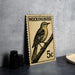 A vintage postage stamp featuring a bird, likely a Mockingbird, perched on a branch.