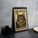 A wooden frame with a postage stamp design featuring a cat, placed on a table next to some black camera lenses.