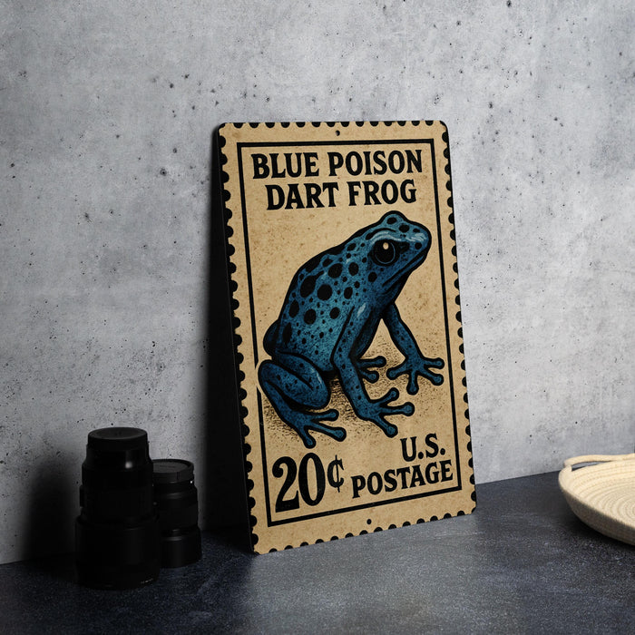A metal sign featuring a blue poison dart frog, with a price of 20 cents postage, is displayed on a table.