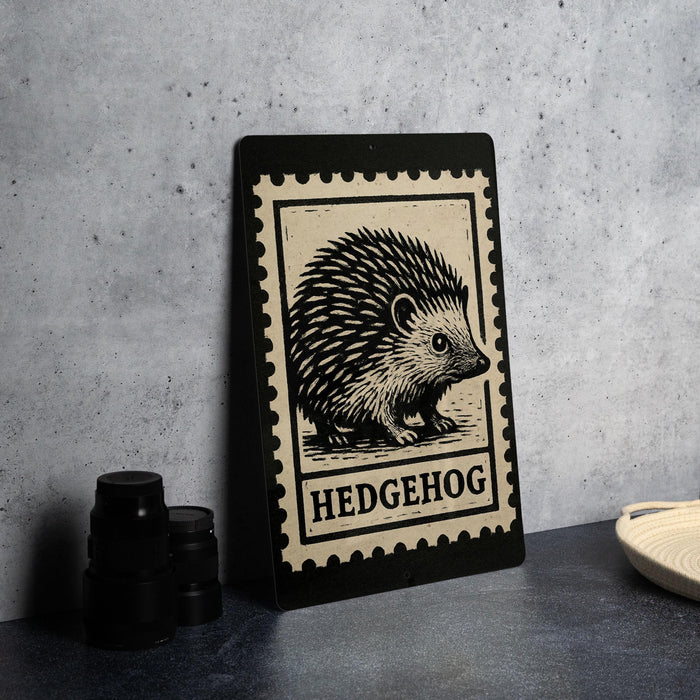 A framed image of a hedgehog is displayed on a wall, with a stack of black camera lenses to the left and a woven basket to the right.