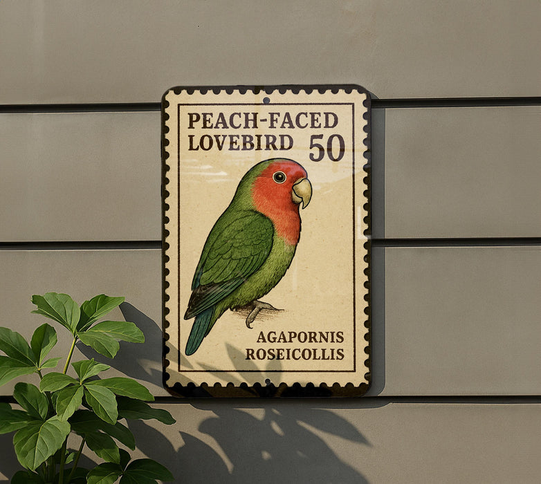 A postage stamp featuring a colorful parrot, specifically a peach-faced lovebird, is displayed on a wall.