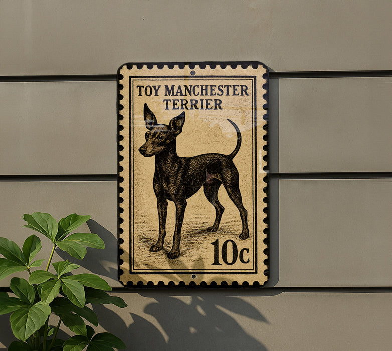 A toy Manchester Terrier dog is depicted on a postage stamp-like sign, mounted on a wall.