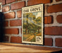 A vintage-style metal sign with a painting of a tree-lined path hangs on a brick wall.