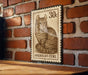 A metal sign featuring a cat illustration and the text "AMERICAN CURL" is displayed on a brick wall.