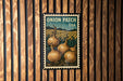 A vintage-style postage stamp featuring an illustration of onions growing in a field, with the text "Onion Patch USA" printed on it.