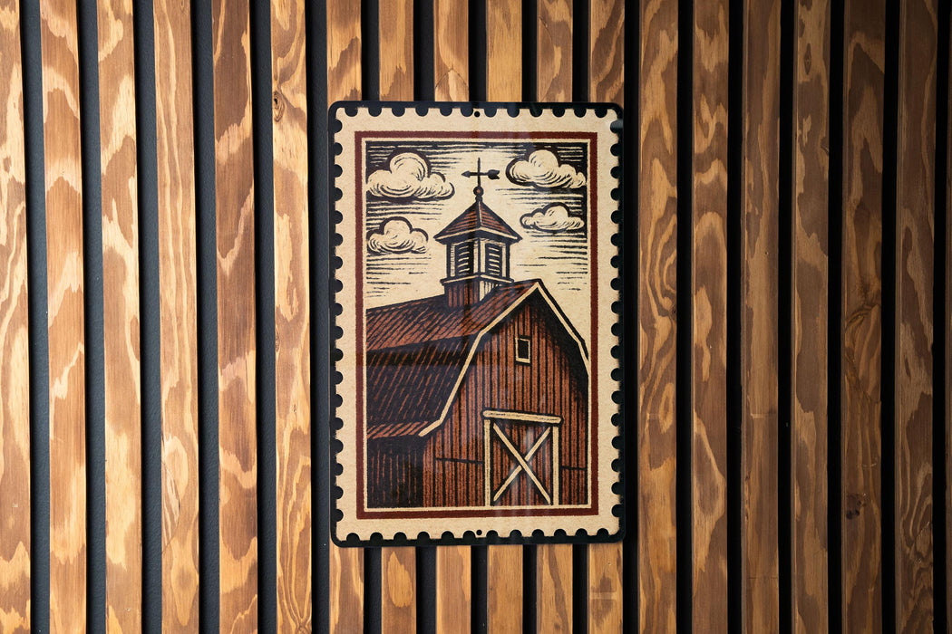 A framed illustration of a barn with a steeple is displayed on a wooden wall.