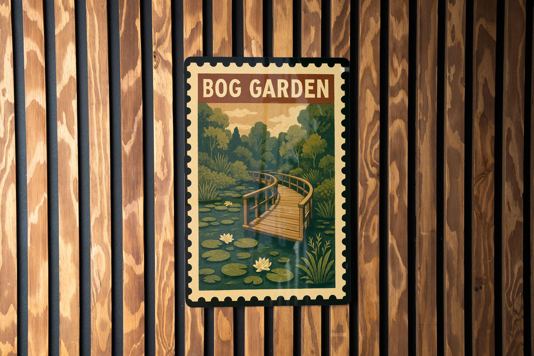 A vintage-style postage stamp depicting a wooden bridge over a pond with lily pads, hanging on a wooden wall.