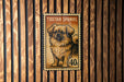 A postage stamp featuring a Tibetan Spaniel dog, with the text "TIBETAN SPANIEL" and "40c" printed on it.