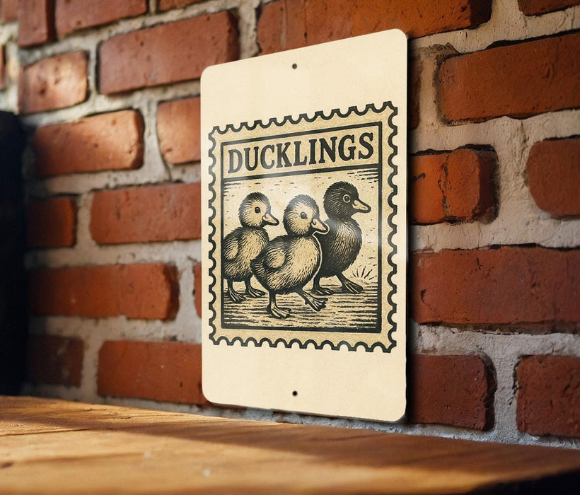 A sign with the word "DUCKLINGS" printed on it, featuring an illustration of three baby ducks.