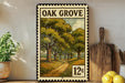 A vintage-style metal stamp depicting a scenic path through a wooded area, with the text "OAK GROVE" prominently displayed.