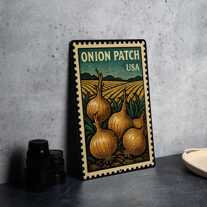 A metal stamp with an illustration of onions and a field, labeled "Onion Patch USA".