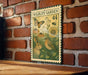 a vintage-style metal sign with illustrations of a rabbit, a bird, and flowers, mounted on a brick wall.
