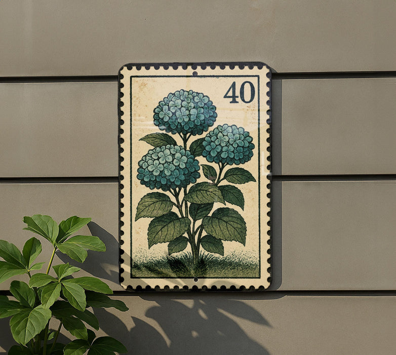 a postage stamp-like frame with a floral design, mounted on a wall next to a plant.