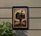 a black and gold postage stamp-like sign with a depiction of a mailbox on a wall.