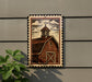 a wooden barn with a steep roof and a cross on top, mounted on a wall.