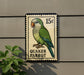 A postage stamp featuring a Quaker Parrot, with the number 15 cents printed on it.