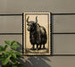 a large, detailed illustration of a yak or ox with long horns, mounted on a wall.