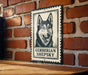 A metal sign featuring a black and white illustration of a German Shepherd dog, with the text "GERBERIAN SHEPKY" below the image.
