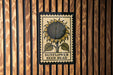 A framed illustration of a sunflower is displayed on a wooden wall.