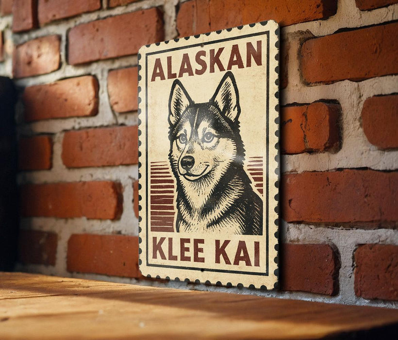 A wooden table with a wooden border, against a brick wall. There is a framed poster of a dog, specifically an Alaskan Klee Kai, hanging on the wall.